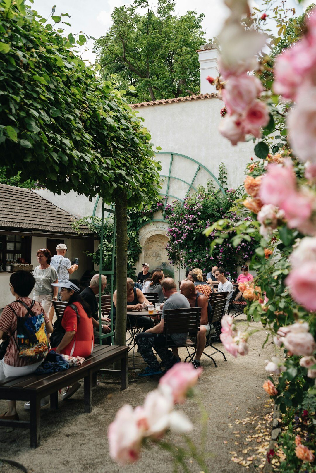 Small team of Czech garden magazine editors standing in a garden